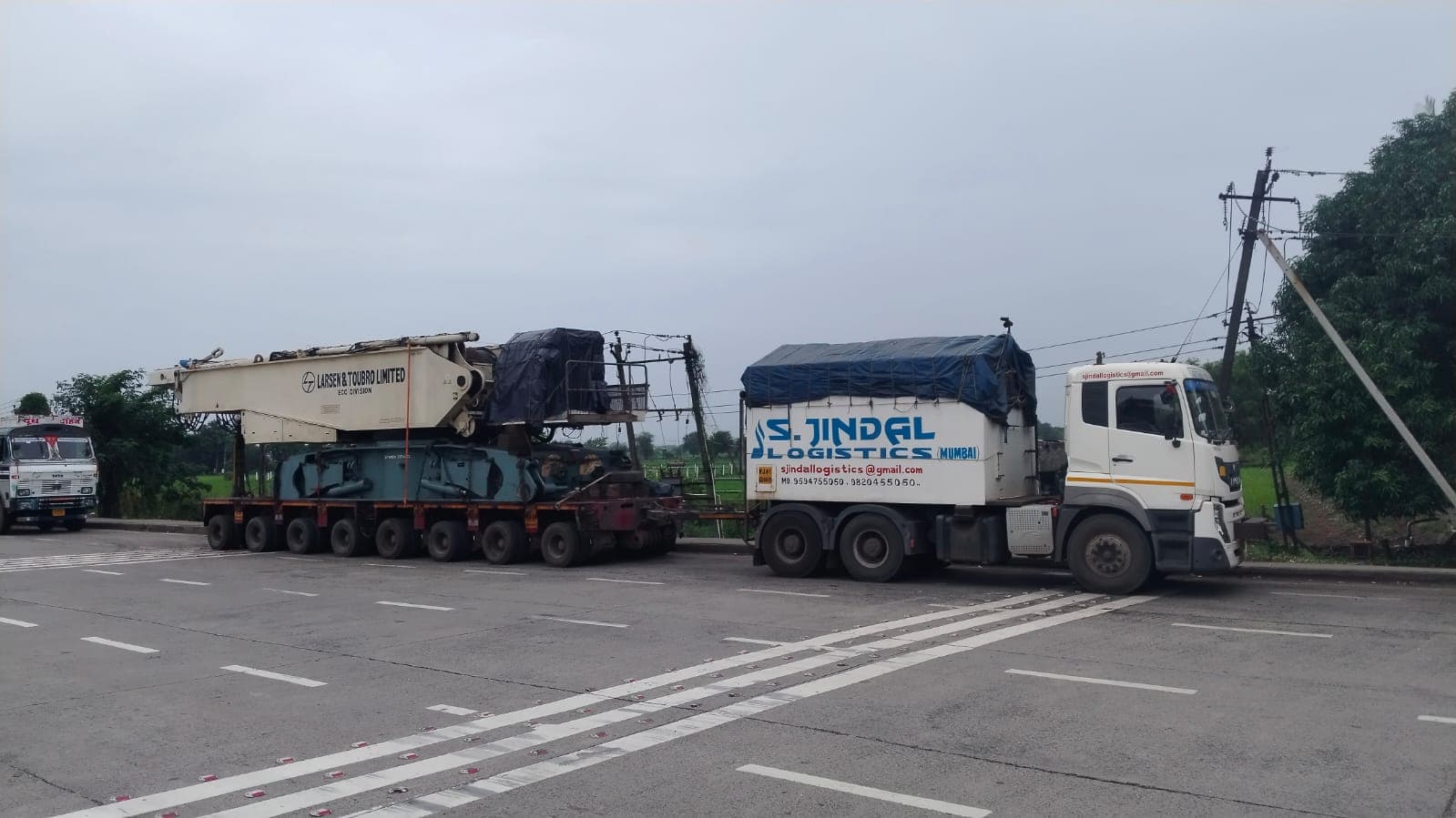 L&T ECC division equipment on multi-axle lines — S Jindal Logistics fleet on the road.