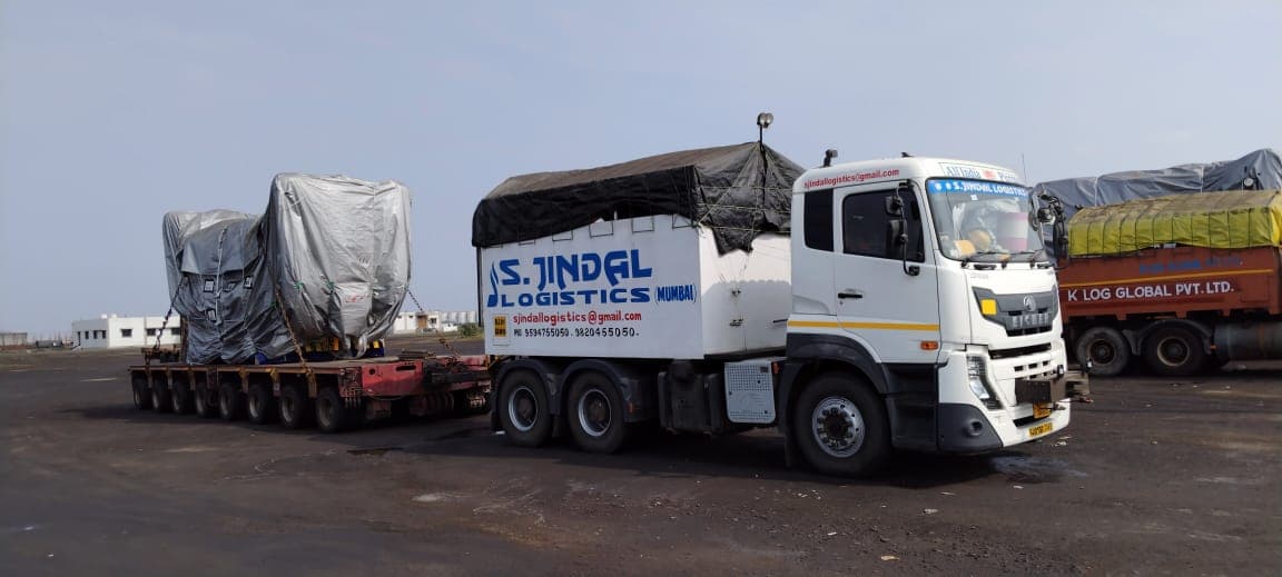 Tarped industrial machinery on low-bed — S Jindal Logistics fleet.